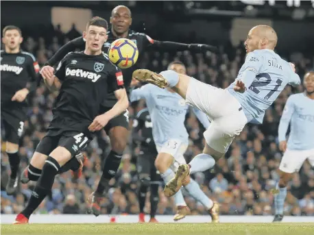  ??  ?? David Silva hits Manchester City’s winner against battling West Ham at the Etihad Stadium yesterday.