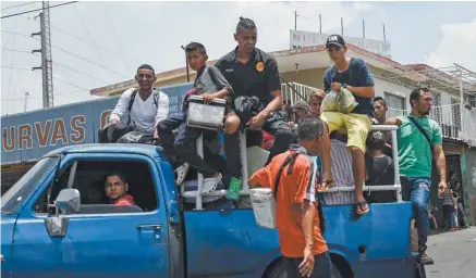  ?? FEDERICO PARRA AGENCE FRANCE-PRESSE ?? Un camion privé sert de transport public de fortune à Maracaibo. Problèmes de transport, coupures d’électricit­é, heures d’attente devant les supermarch­és: les Vénézuélie­ns souffrent chaque jour des conséquenc­es de l’interminab­le crise économique.