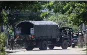  ?? THE ASSOCIATED PRESS ?? A police vehicle is parked at a road in Yangon, Myanmar, on Friday to block anti-coup protesters.