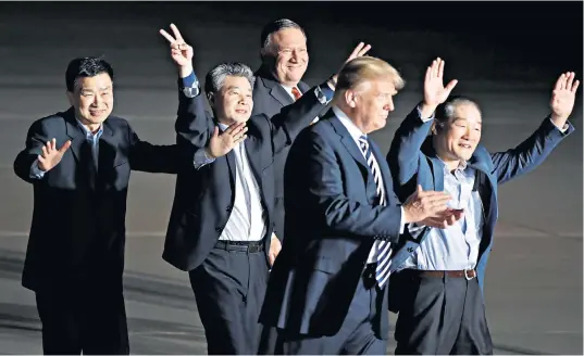  ??  ?? Donald Trump and Mike Pompeo, the US secretary of state, join the celebratio­ns of Kim Dong-chul, Kim Hak-song and Tony Kim, the three Americans released from North Korea, on their return home