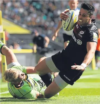  ??  ?? Sean Maitland evades Saints’ Harry Mallinder to score Saracens’ fifth try during the Aviva Premiershi­p match at Twickenham yesterday.