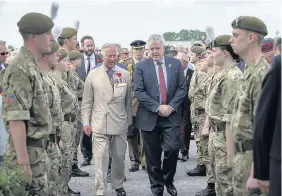  ??  ?? &gt; The Prince of Wales arrives with First Minister Carwyn Jones at the Welsh Memorial in Flanders