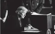  ?? Al Drago / Bloomberg ?? President Donald Trump signs Space Force into law Friday at Joint Base Andrews, Md.