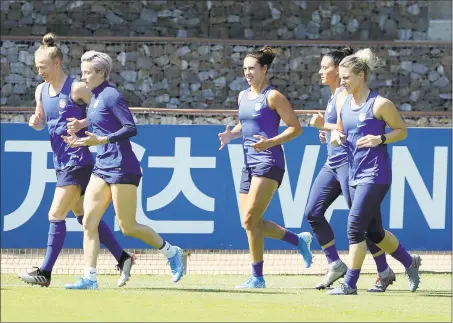  ?? Elsa / Getty Images ?? From left, the United States’ Emily Sonnett, Megan Rapinoe, Carli Lloyd, Ali Krieger and Julie Ertz warm up during a training session at Gymnase Park des Sport on Saturday in Lyon, France.