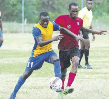  ??  ?? Lucea FC’S Sewayne Stewart (left) battles with Granville United’s Romaine Reid.