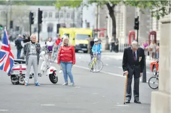  ??  ?? Second World War veteran Lou Myers, 92, observes the two minutes silence at the Cenotaph in Whitehall, London, to mark the 75th anniversar­y of VE-Day on Friday.