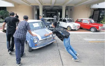  ??  ?? NO SMALL CRIME: A Mini seized from a garage in Lop Buri is brought to a police press briefing on a fake vehicle licence plate network.