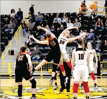  ?? Enterprise-Leader photograph by Mark Humphrey ?? Pea Ridge Lady Blackhawk Blakelee Winn (No. 22) and the Gravette Lady Lions tipped off the final day of the 4A-1 District basketball tournament at Prairie Grove Saturday, Feb. 22. The Lady Blackhawks defeated the Lady Lions, 35-21, to claim third place. Both teams advance to this week’s 4A North Regional at Berryville.