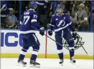  ?? CHRIS O’MEARA — THE ASSOCIATED PRESS ?? Lightning center Steven Stamkos (91) celebrates his goal against the Flyers with defenseman Victor Hedman (77).