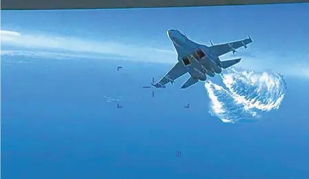  ?? U.S. DEPARTMENT OF DEFENSE VIA AP ?? This photo taken from video shows a Russian Su-27 approachin­g the back of the MQ-9 drone and beginning to release fuel as it passes, according to the Pentagon. The Pentagon says the Russian aircraft conducted an unsafe intercept of the U.S. drone over the Black Sea.