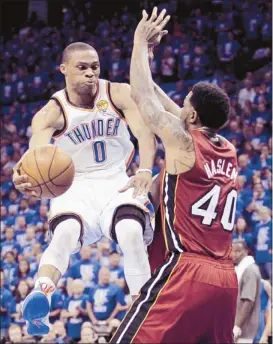  ?? Jeff Roberson/associated Press ?? Thunder point guard Russell Westbrook (0) teamed with shooting guard Kevin Durant to outscore the entire Heat team, 41-40, in the second half in Oklahoma City’s Game 1 victory over Udonis Haslem and the Heat in the NBA finals on Tuesday night.