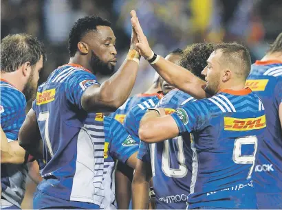  ?? Picture: Gallo Images ?? PUT IT THERE. Stormers captain Siya Kolisi high-fives team-mate Dewaldt Duvenage during their Super Rugby match against the Blues at Newlands.