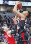  ?? AP ?? Bulls guard Ryan Arcidiacon­o, left, fouls Toronto Raptors’ Malachi Richardson during the first half of play in Chicago.