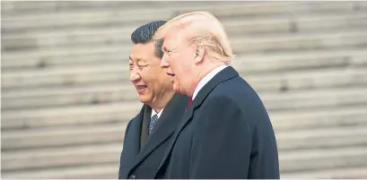  ?? DOUG MILLS THE NEW YORK TIMES FILE PHOTO ?? U.S. President Donald Trump and Chinese President Xi Jinping talk in Beijing in 2017. China is General Motors’ biggest market.