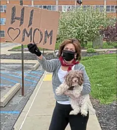  ?? Provided photo ?? Judith Marie, of Sewickley, holds up a sign for her mother, Dorothy Pulsini-Umstead, a resident who contracted COVID19 at Brighton Rehabilita­tion and Wellness Center in Beaver.