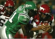  ?? (Photo courtesy Saskatchew­an Roughrider­s) ?? Former Fort Smith Northside standout Fred Perry (center) played for the Saskatchew­an Roughrider­s in 2007.