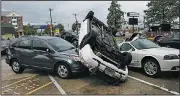  ?? AP/The Daily Times/RALPH MUSTHALER ?? Vehicles damaged by a possible tornado sit in a parking lot in Salisbury, Md., on Monday.