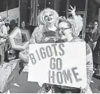  ?? JEFF KOWALSKY/ AFP VIA GETTY IMAGES ?? Pro- and anti- drag queen protesters rally outside a book store’s Drag Queen Story Time in Royal Oak, Mich., on March 11.