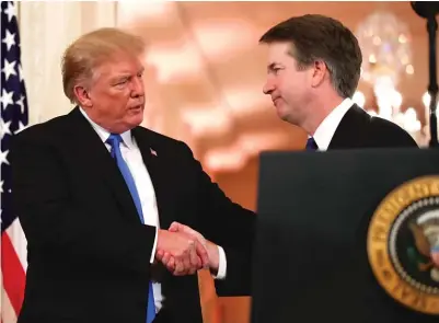  ?? ALEX BRANDON/ AP ?? President Donald Trump shakes hands with Judge Brett Kavanaugh, his Supreme Court nominee, in the East Room of the White House.