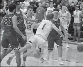  ?? RICK PECK SPECIAL TO MCDONALD COUNTY ?? McDonald County’s Blake Gravette gets tripped while driving the lane during the Mustangs 56-47 loss on Monday night at MCHS to open the 2017-2018 basketball season.