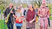  ?? AP PHOTO/ALBERTO PEZZALI ?? People dressed in costumes take part in a silent disco event Saturday outside the Brighton Dome in Brighton, England.