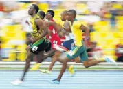  ??  ?? SPEED KING: Usain Bolt surges ahead of Anaso Jobodwana of South Africa, right, in the 200m semifinal during the IAAF World Athletics Championsh­ips in Moscow last month