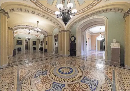  ?? Photos / AP ?? Empty corridors around the Senate are seen on Capitol Hill in Washington as Benjamin Franklin, right, ponders the shutdown.