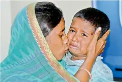  ??  ?? Ms Sanju Chamar and her son Ayush, who was kidnapped from Seunderaba­d railway station a day ago, break down after they were reunited by police.