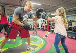  ?? PETER McCABE ?? Lily Friedman, 7, of Pierrefond­s does a round in the ring with Otis Grant during the boxathon fundraiser in Dorval on Sunday.