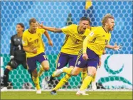  ?? Darko Bandic / Associated Press ?? Sweden’s Emil Forsberg, right, celebrates with teammates after scoring against Switzerlan­d on Tuesday.