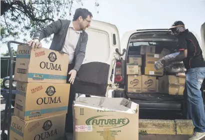  ?? Picture: Jacques Nelles ?? NO MORE HUNGER. Tuks FM sales manager Tony Graham, above left and on right, offloads groceries and other supplies sponsored by the Menlyn Park Shopping Centre yesterday for the 10 000 University of Pretoria students who form part of the missing middle.