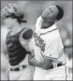  ?? AP/JOHN BAZEMORE ?? Ronald Acuna Jr. of the Atlanta Braves winces after being hit by a pitch in the first inning against the Miami Marlins on Wednesday. Marlins pitcher Jose Urena was handed a six-game suspension Thursday.