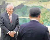  ?? ANDY WONG, POOL ?? Secretary of State Rex Tillerson looks at Chinese President Xi Jinping during a meeting at the Great Hall of the People in Beijing on Saturday.