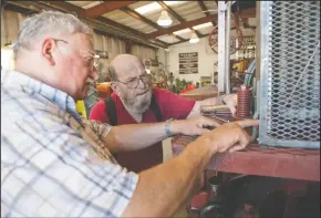  ?? NEWS-SENTINEL PHOTOGRAPH­S BY BEA AHBECK ?? Harley Zimmerman and Ken Mettler inspect a part as they restore a 100-year-old Holt 75 Tractor at the San Joaquin Historical Museum at Micke Grove Regional Park in Lodi on Tuesday.