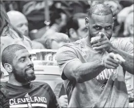  ??  ?? BENCH-WARMING SPELL: LeBron James (right) and Kryie Irving hang out on the bench during a March 4 game vs. the Heat in which they did not play. The NBA faces a tough situation weighing the benefits of player rest against fans’ feeling robbed of seeing...