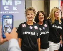  ?? FILE ?? Supporters of then-candidate Donald Trump pose at Kennesaw State University in Georgia last year. When Hillary Clinton described certain Trump supporters as a “basket of deplorable­s,” there was outrage.