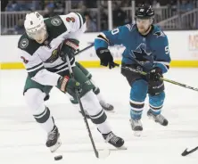  ?? Jeff Chiu / Associated Press ?? Minnesota center Charlie Coyle skates in front of San Jose center Chris Tierney in the first period Saturday.