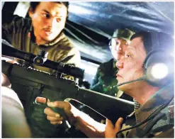  ?? (Malacañang Photo) ?? PRESIDENTI­AL SNIPER – President Duterte aims a rifle during a visit to a military sniper’s nest in Marawi City Thursday. The President was reported to have fired twice at an Islamist jihadist position.