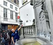  ?? AFP ?? Brussels’ energy technician Regis Callens points at the Mannekenpi­s landmark statue in Brussels. —