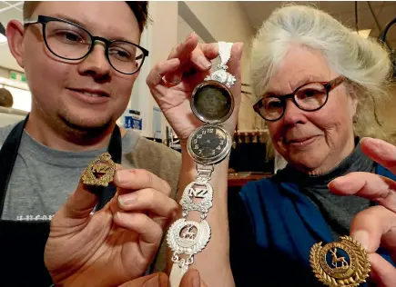  ?? PHOTO: MARTIN DE RUYTER/FAIRFAX NZ ?? Joel Whitwell of Benjamin Black Goldsmiths and Jackie Cook with her grandfathe­r’s specially modified World War I era Rolex watch. Cook asked the goldsmiths to create a unique silver watch strap to match the watch.