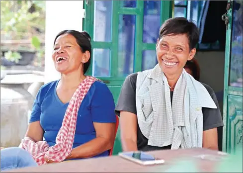  ?? HONG MENEA ?? Pel Nhork (left) and her transgende­r husband, Heng Ny, discuss the adoption of their children at their house in Takeo province this week.