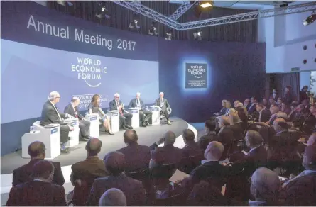  ?? — AFP ?? Participan­ts attend a meeting at the World Economic Forum in Davos.