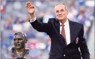  ?? Bill Kostroun / Associated Press ?? Former New York Giants linebacker Sam Huff waves to the fans as he stands behind his Hall of Fame bust during the halftime show of an NFL game between the Giants and the Denver Broncos on Sept. 15, 2013, in East Rutherford, N.J. Huff, the hard-hitting Hall of Fame linebacker who helped the Giants reach six NFL title games from the mid-1950s to the early 1960s and later became a popular player and announcer in Washington, died Saturday. He was 87.