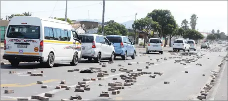  ?? Picture: Ayanda Ndamane/African News Agency (ANA) ?? NO-GO AREA: Protesting Gugulethu backyarder­s littered roads with objects including bricks during a protest yesterday.