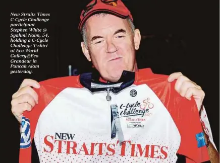  ??  ?? New Straits Times C-Cycle Challenge participan­t Stephen White @ Syahmi Naim, 54, holding a C-Cycle Challenge T-shirt at Eco World Gallery@Eco Grandeur in Puncak Alam yesterday.