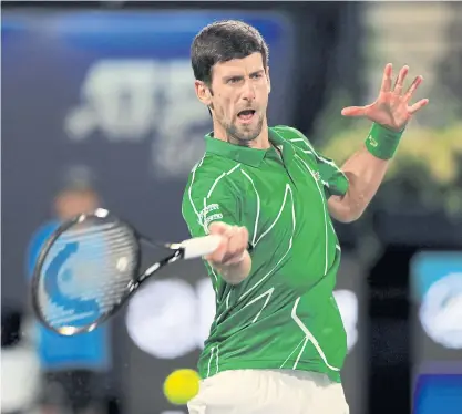  ??  ?? Novak Djokovic hits a forehand return during his quarter-final match against Karen Khachanov.