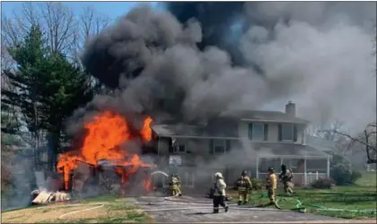  ?? SUBMITTED PHOTO ?? Firefighte­rs battle house fire on the 100block of Beechtree Drive in Marple Easter Sunday.