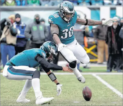  ?? AP PHOTO ?? Philadelph­ia Eagles’ Nick Foles (left) recovers a fumble as Corey Clement leaps past during the first half of an NFL game against the Dallas Cowboys on Sunday in Philadelph­ia.