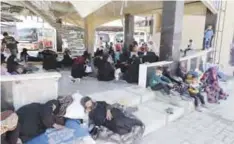  ?? — AFP ?? ALEPPO: Displaced Syrians who fled with their families Islamic State controlled areas in Raqa, Deir Ezzor and Mayadeen gather at Aleppo’s bus station of Ramussa.