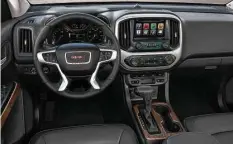  ??  ?? The 2017 GMC Canyon Denali’s Jet Black interior includes leather heated and ventilated front seats, a unique instrument panel and console trim, Denali-logo sill plates and floor mats, heated steering wheel, GMC IntelliLin­k with Navigation and an...